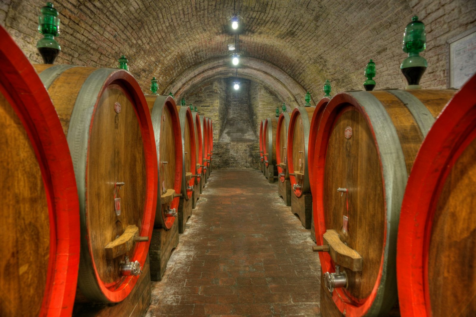 Bodega abovedada con filas de barricas de madera